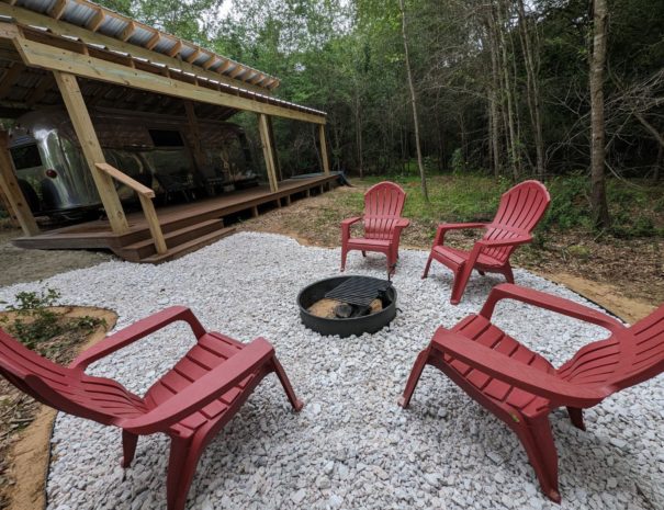 Swing into cozy evenings by the fire pit, surrounded by Adirondack chairs and our inviting swings