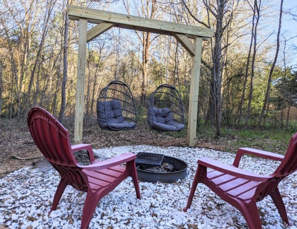 Swing into cozy evenings by the fire pit, surrounded by Adirondack chairs and our inviting swings.