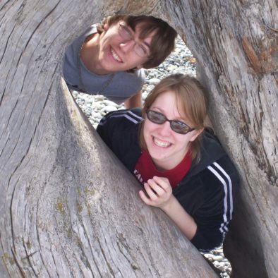 Siblings Emmelyn and Nick looking through a hole in a tree during their high school travels to Washington State