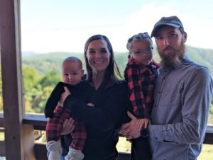 Nick and Olivia's family picture with their preschool aged daughter and baby boy