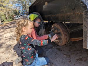 The Owners' Kids helping change a tire at Riveted Retreat